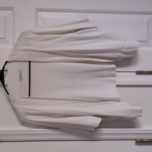 Short sleeved, half length sweater  length ends above waist line.